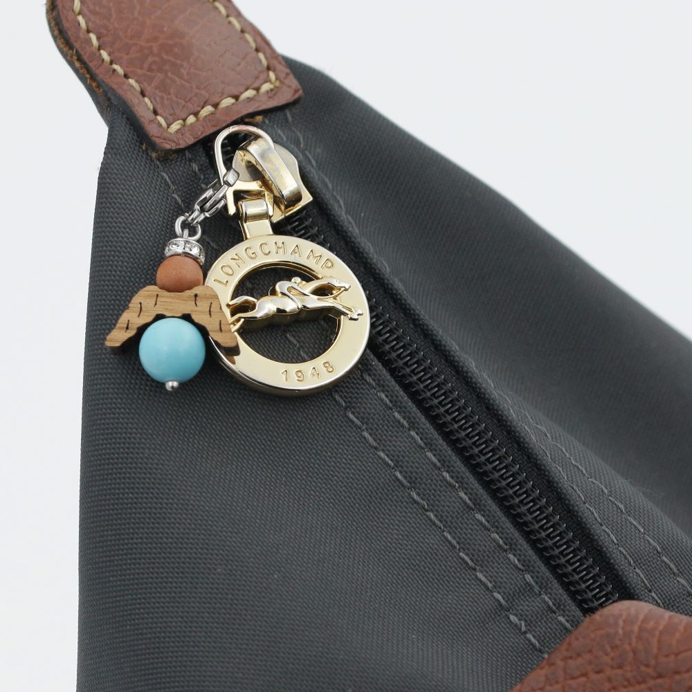 A guardian angel and companion made of walnut with sparkling crystal