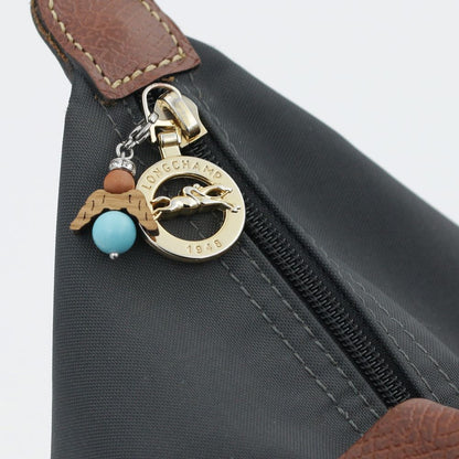 A guardian angel and companion made of walnut with sparkling crystal